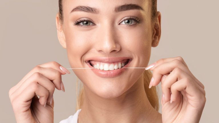 woman flossing teeth