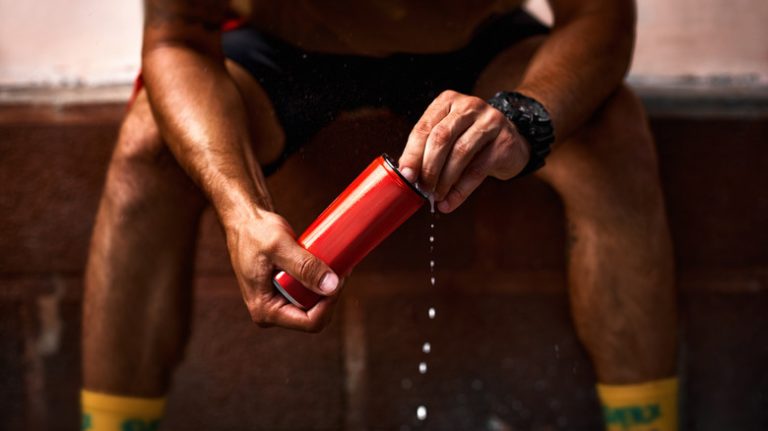 A man holds an energy drink