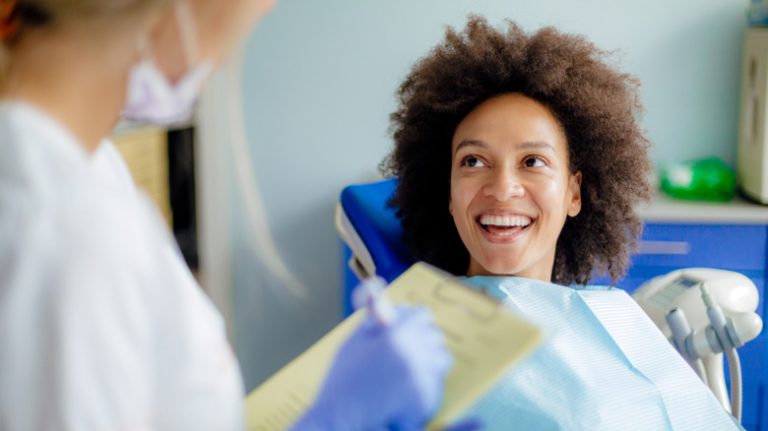 Smiling patient in dentist chair