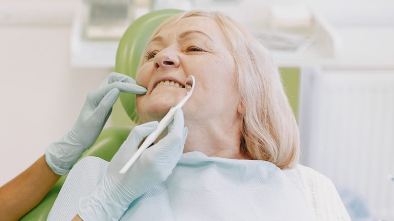 Older woman receiving dental exam