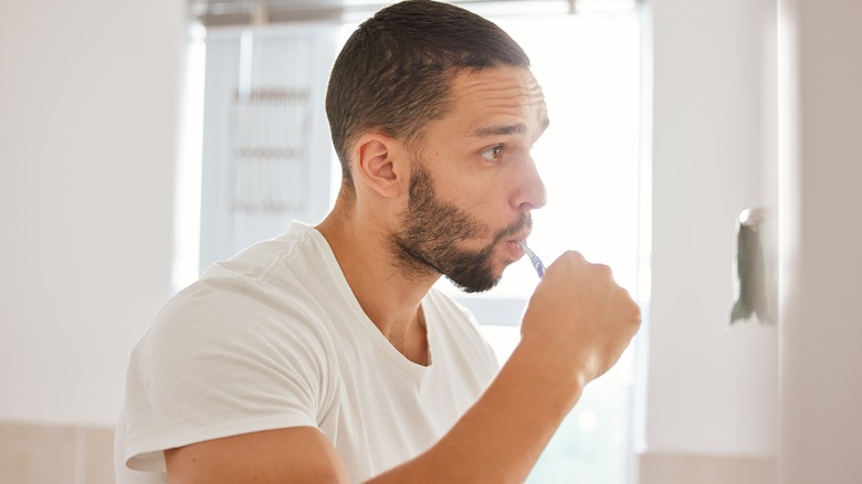 man brushing teeth