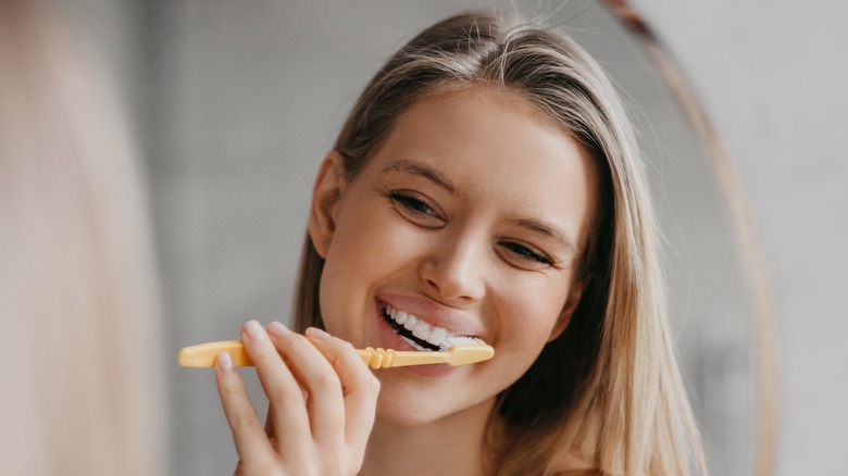 Young woman brushing her teeth