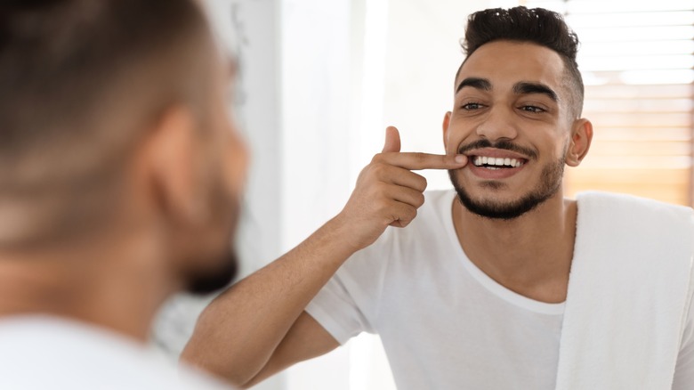 Man smiling in mirror