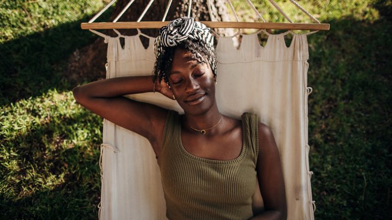 Woman relaxing in hammock