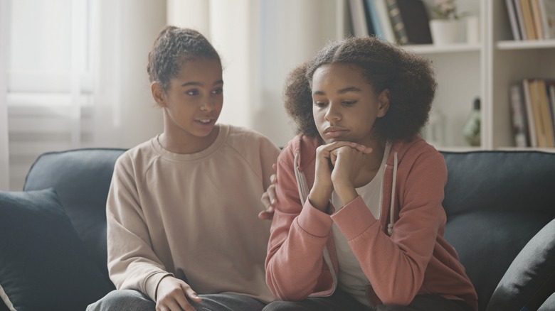 Sad teen girls on couch