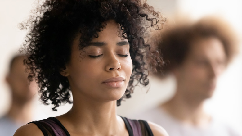 woman breathing deeply with eyes closed