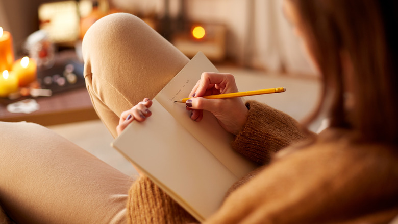 woman writing in a journal