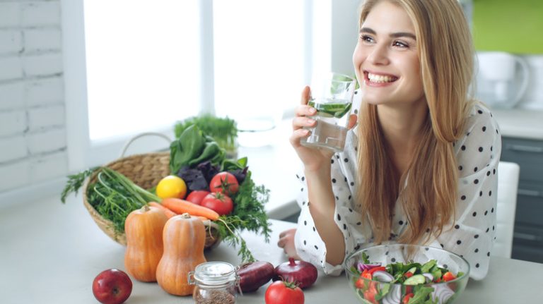 Woman with a variety of vegetable foods