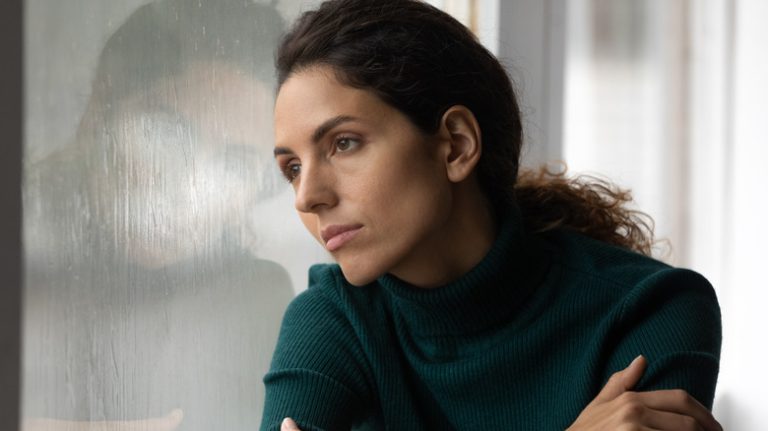 Woman looking out window