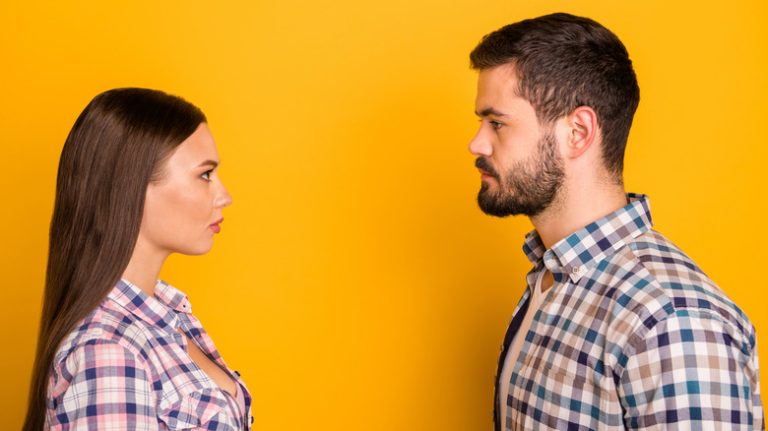 man and woman standing opposite