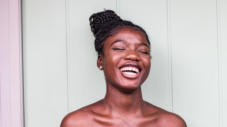 Woman with braided topknot smiling