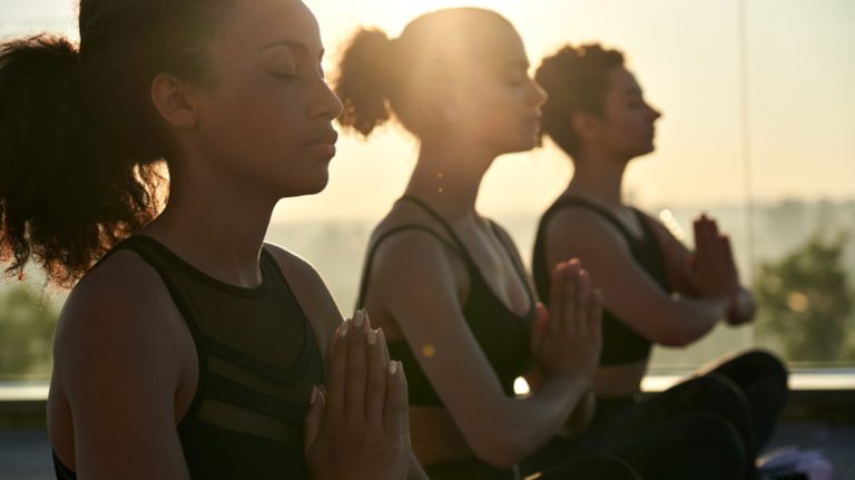 group of Black women meditating