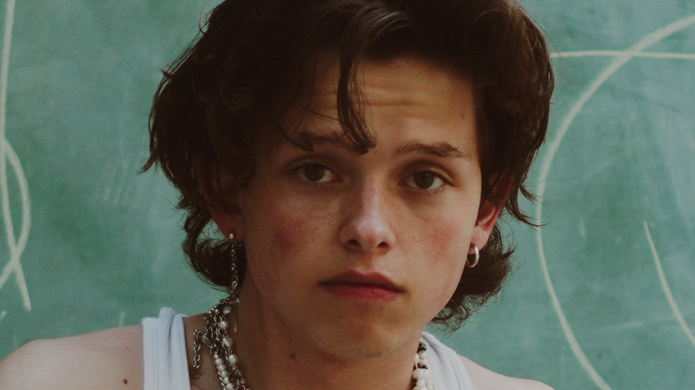 Jacob Sartorius sitting in front of a chalkboard