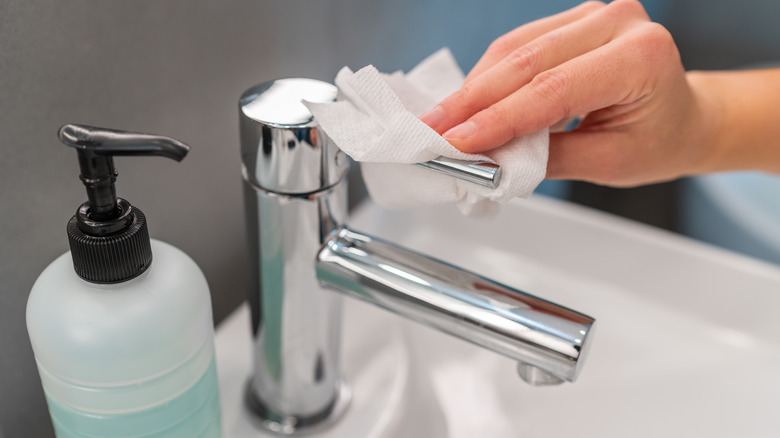 close-up of someone cleaning the faucet