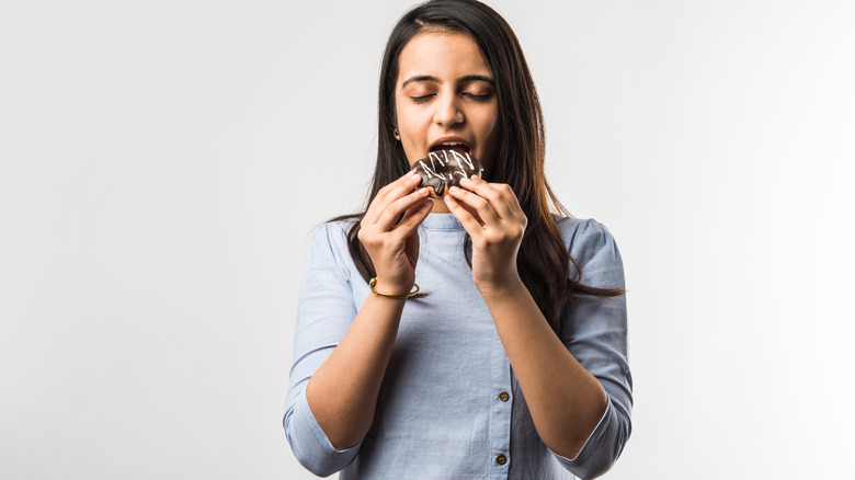 woman eating donut