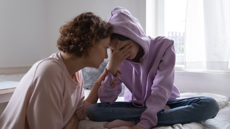 Mother and daughter sharing an intense emotional moment