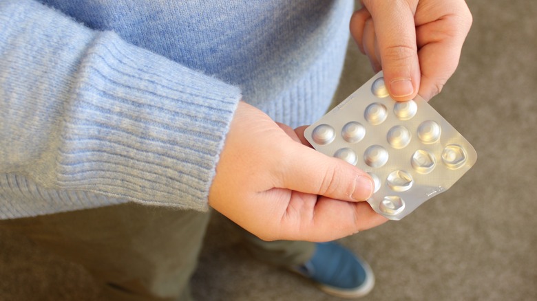 person holding their bipolar medication