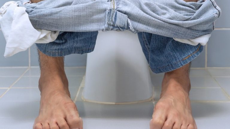 Man sitting on toilet