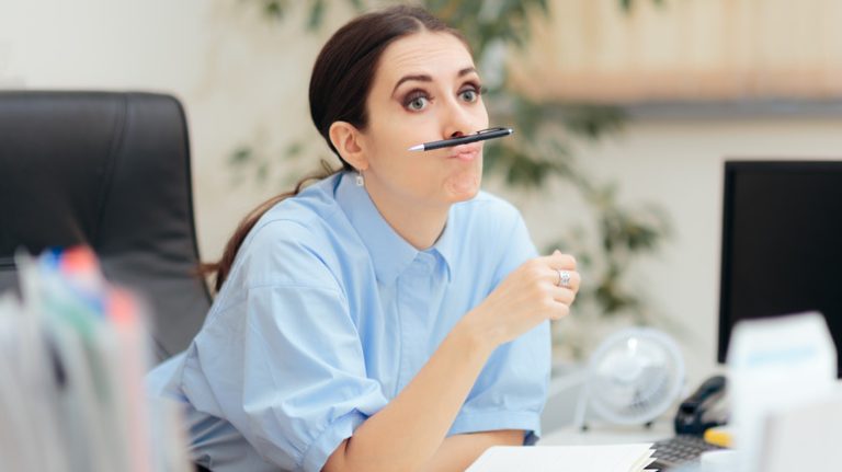 A woman balancing a pen