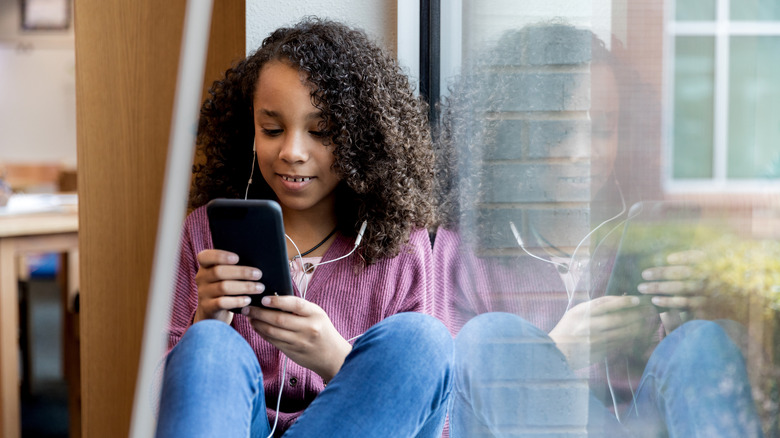 young girl smiling social media phone