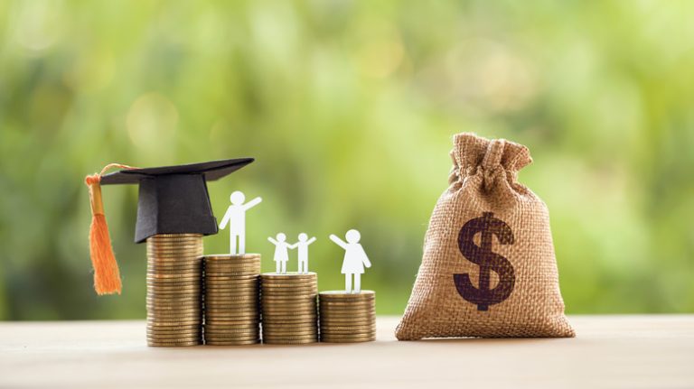 graduation cap on stack of coins