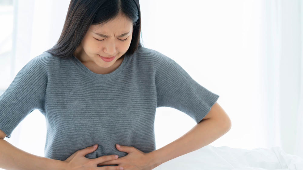 A distressed woman holding her stomach