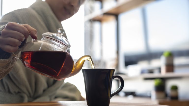 Person pouring black tea