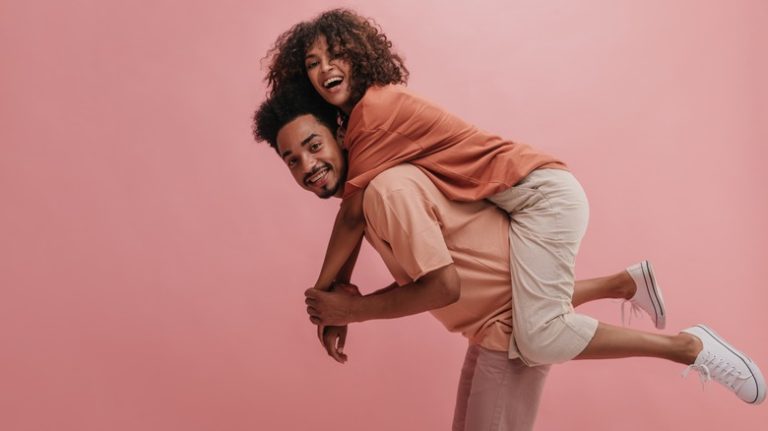 a man giving a woman a piggyback ride