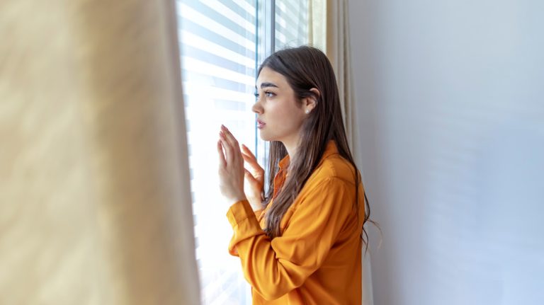 woman looking out window