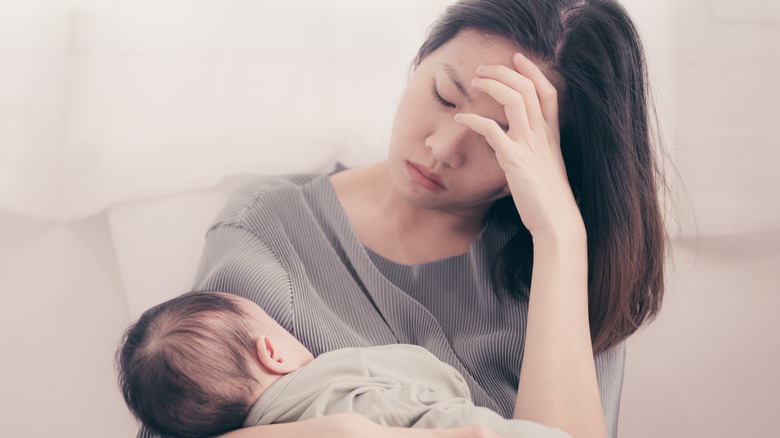 mother holding baby experiencing postpartum depression