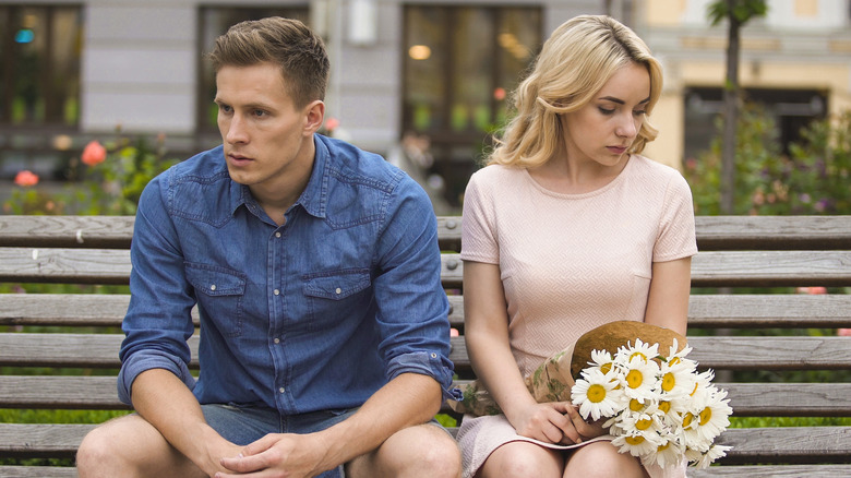 unhappy couple sitting on a bench