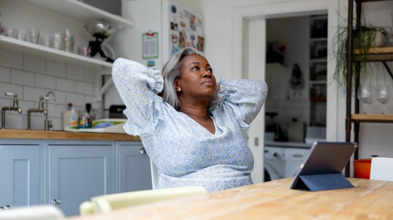 woman sitting at table looking anxious