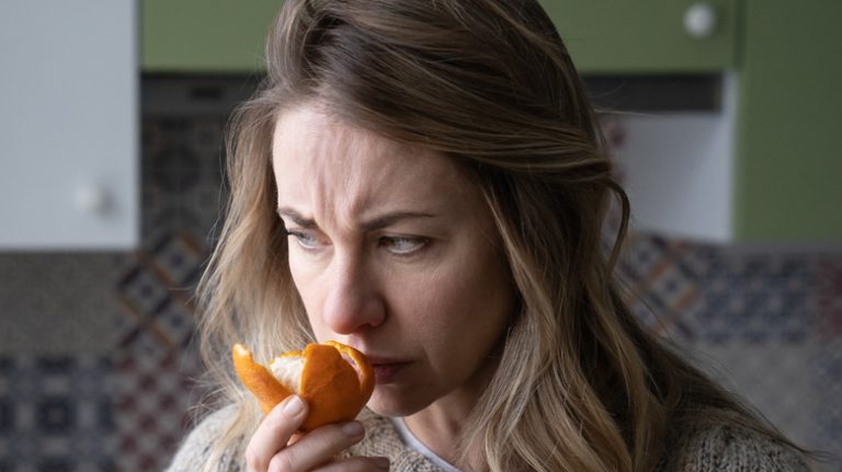 Woman smelling orange