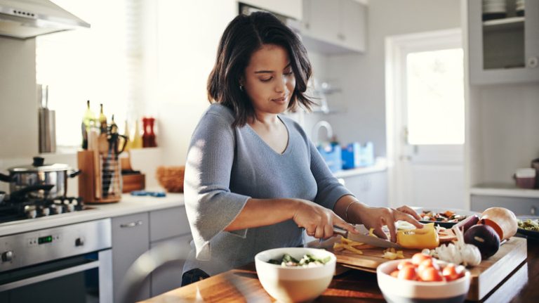 woman cooking a meal at home